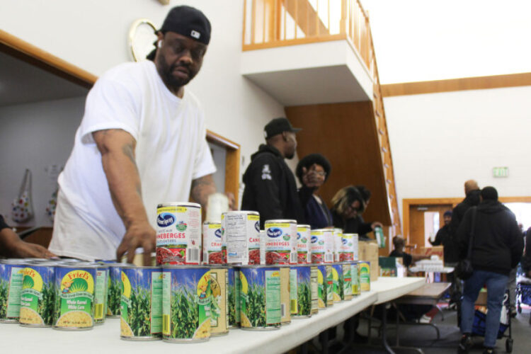 Volunteers stack canned goods at Fountain Square Church of Christ on Indianapolis’ southeast side during a food distribution event on Saturday, Nov. 8, 2025.