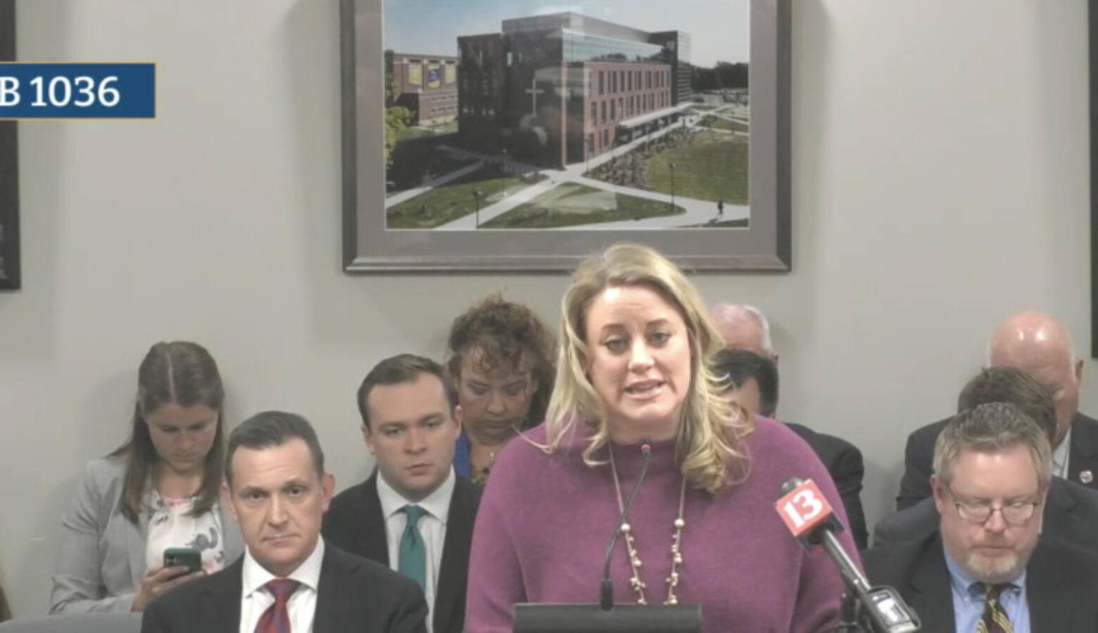 Braelynn Yerington with Champions for Children reads a letter from the grandfather of the Indianapolis five-year-old who died of neglect. Yerington is speaking from a podium with microphones.