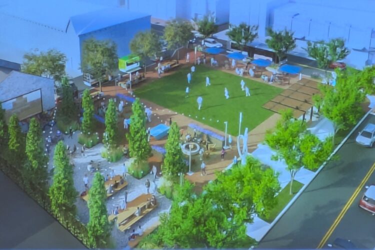 A digital drawing shows a green field surrounded by tables and trees.