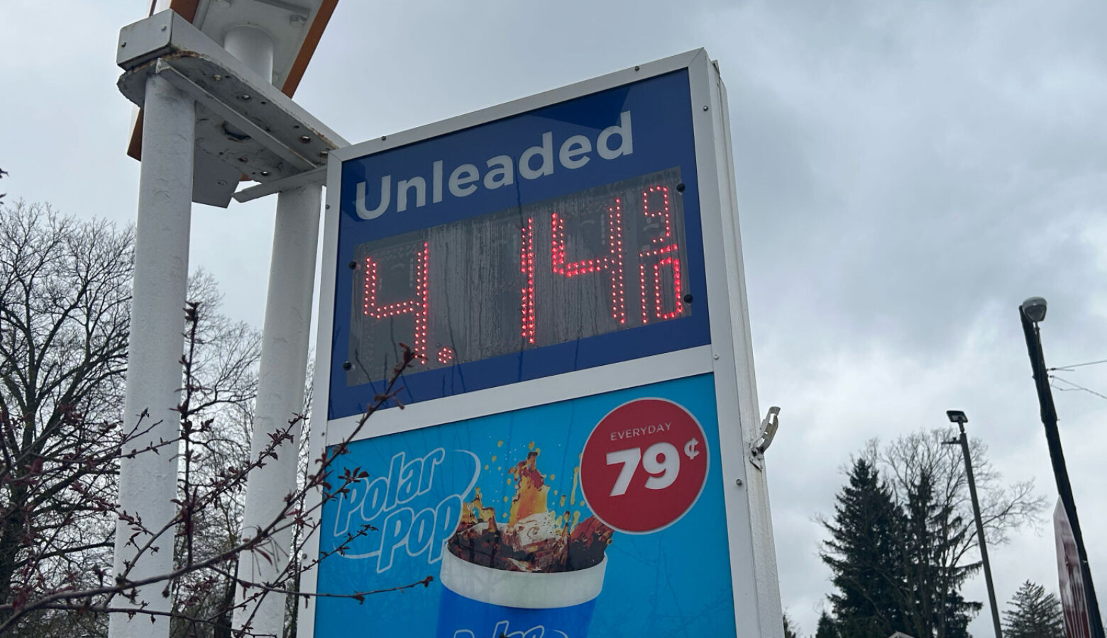 A gas station sign lists the price of unleaded gas as $4.14.
