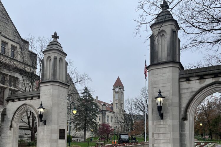 Indiana University's Sample Gates are made of gray stone and topped with pyramid-shaped caps.