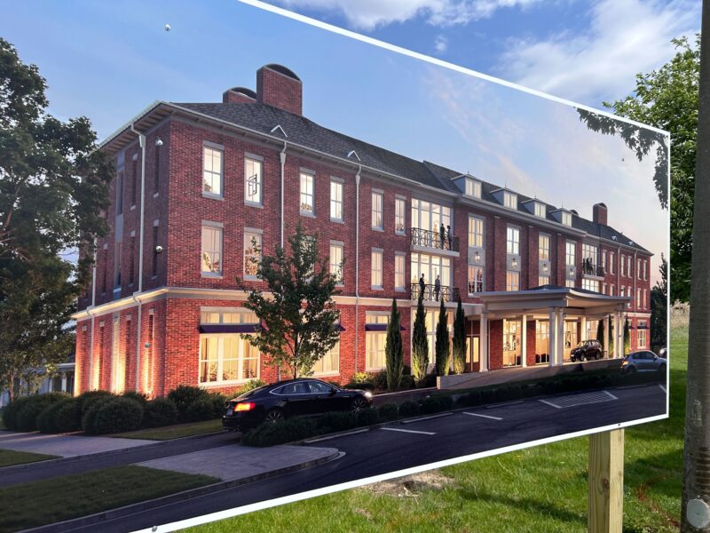 A picture displaying a three story brick building 