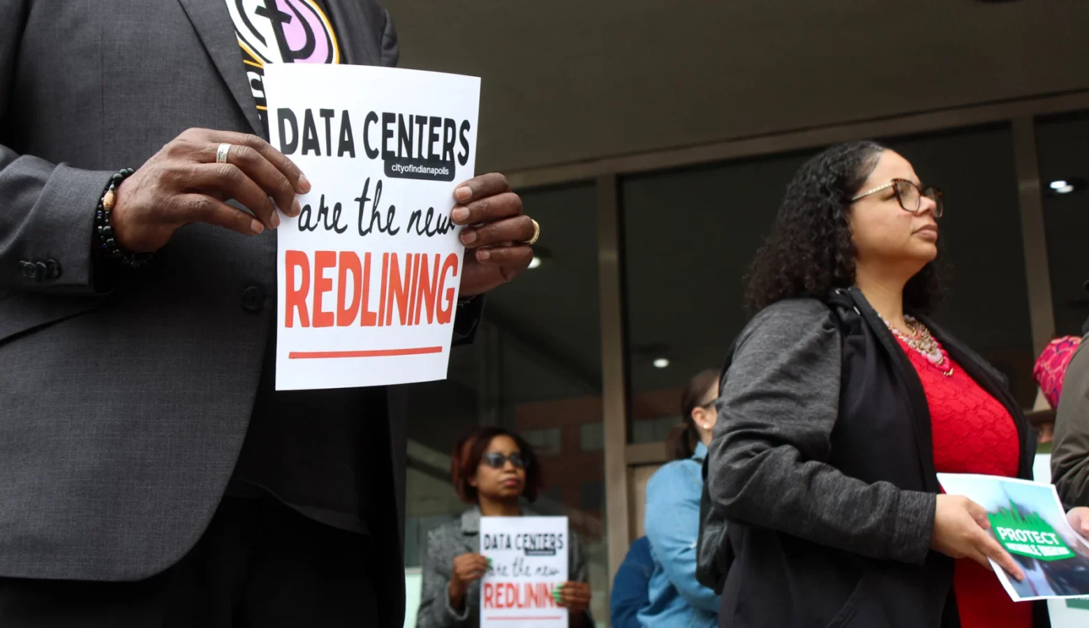 Residents of Martindale-Brightwood voiced their opposition to the proposed data center during a protest outside the Indianapolis City-County Building on Wednesday, April 1, 2026. Protesters appeared calm and holding small signs with slogans such as, "Data Centers are the new REDLINING."