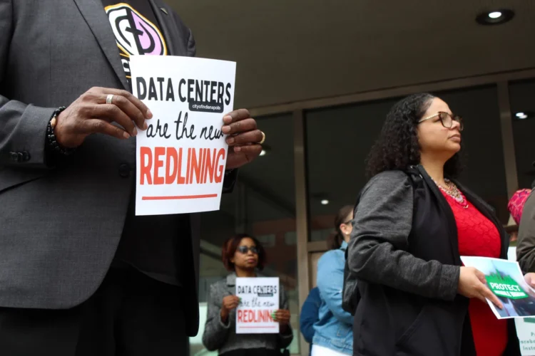Residents of Martindale-Brightwood voiced their opposition to the proposed data center during a protest outside the Indianapolis City-County Building on Wednesday, April 1, 2026. Protesters appeared calm and holding small signs with slogans such as, "Data Centers are the new REDLINING."