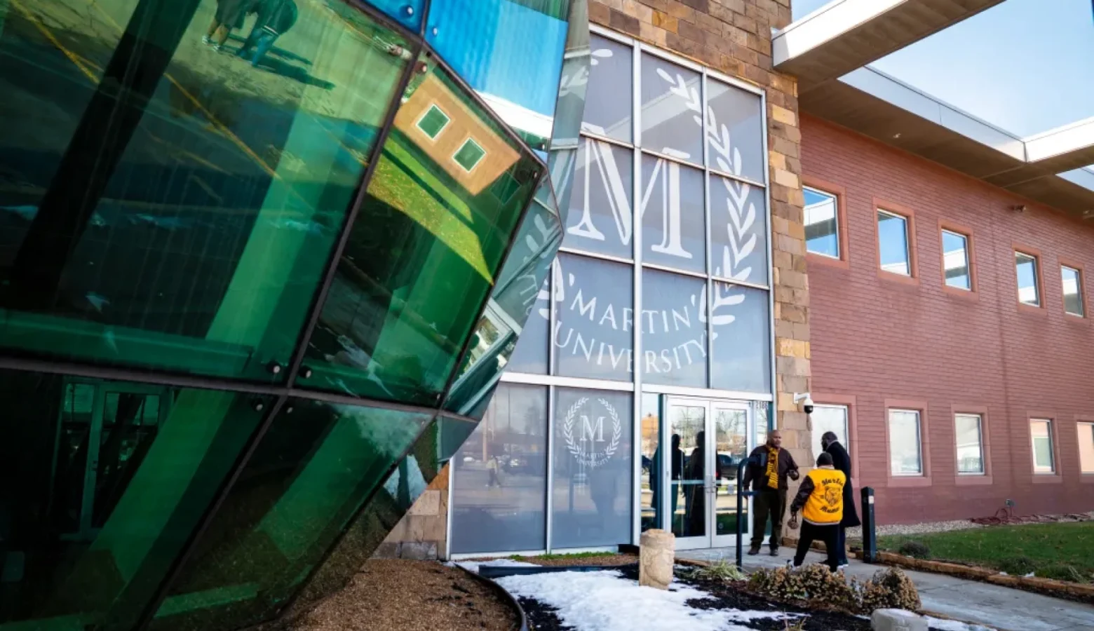 Martin University's main building made of brick and glass is fronted by a giant glass round globe.