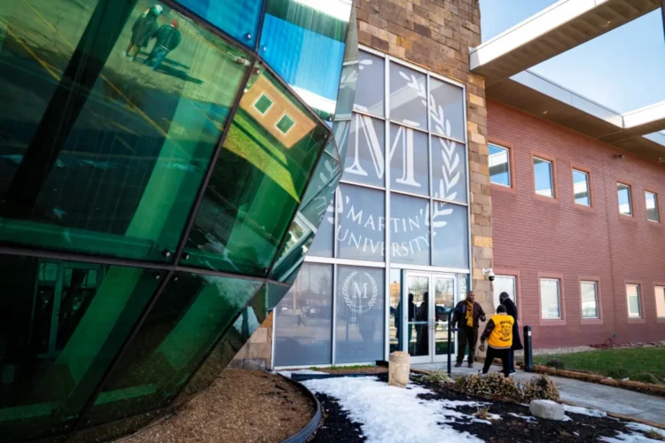 Martin University's main building made of brick and glass is fronted by a giant glass round globe.