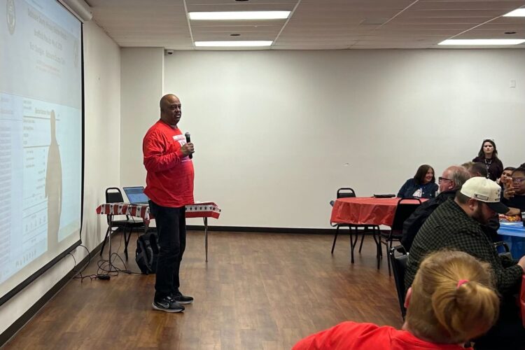 Richard Ivy, wearing a red campaign shirt, addresses an election night party.