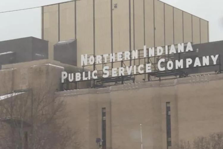 A large, concrete building exterior on a cloudy day with a large sign displaying the name Northern Indiana Public Service Company.