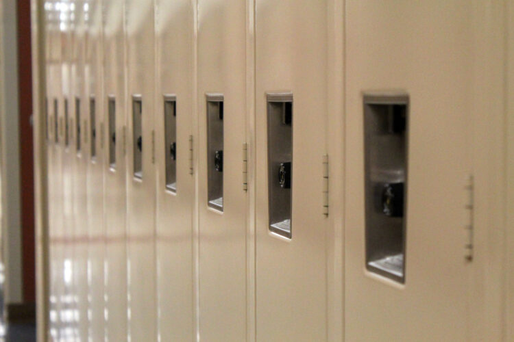 Tan metal lockers inside a high school.