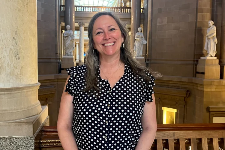Paula Copenhaver stands smiling inside the Indiana Statehouse.