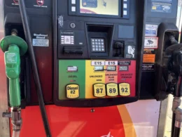 An Indianapolis gas pump shows ethanol allotments in each fuel grade. The pump shows, from left to right, #2 Diesel in a green-painted part of the pump with a diesel dispenser with a green plastic head. Further to the right, in order, we see Unleaded 87 gas highlighted in yellow with 87 octane, then orange-labeled 89 octane Unleaded Plus (both unleaded and unleaded plus show E15 on a label in their respective sections. Finally, in red, we see Unleaded Premium with a label that says "Up to 10% Ethanol." A black-headed gasoline dispenser is positioned to the right of the gasoline choices.