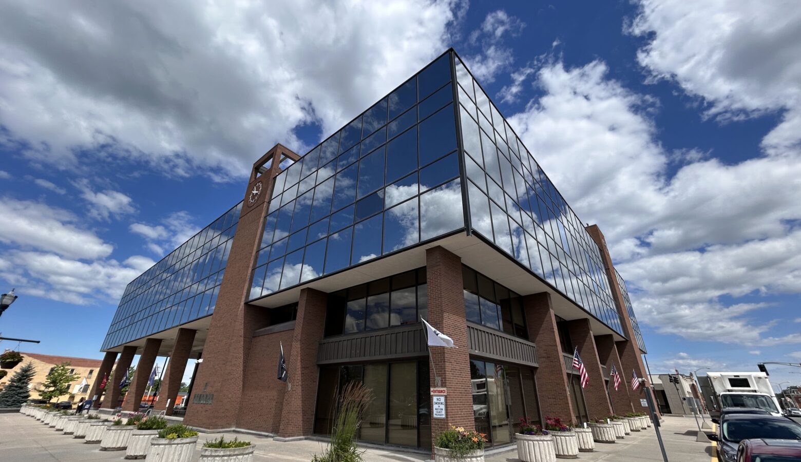 A brick building with large windows on its second floor. The words Madison County Government Center are spelled out on the wall.
