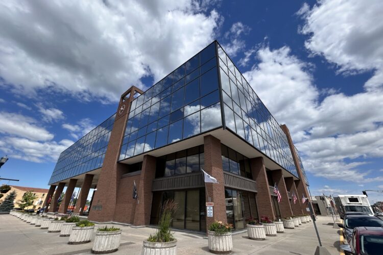 A brick building with large windows on its second floor. The words Madison County Government Center are spelled out on the wall.