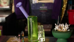 A dab rig sits on the bar inside of WildEye Cannabis, a cannabis consumption lounge in Indianapolis. A table holds a dispenser of pointed cotton swabs and a couple of small bottles.