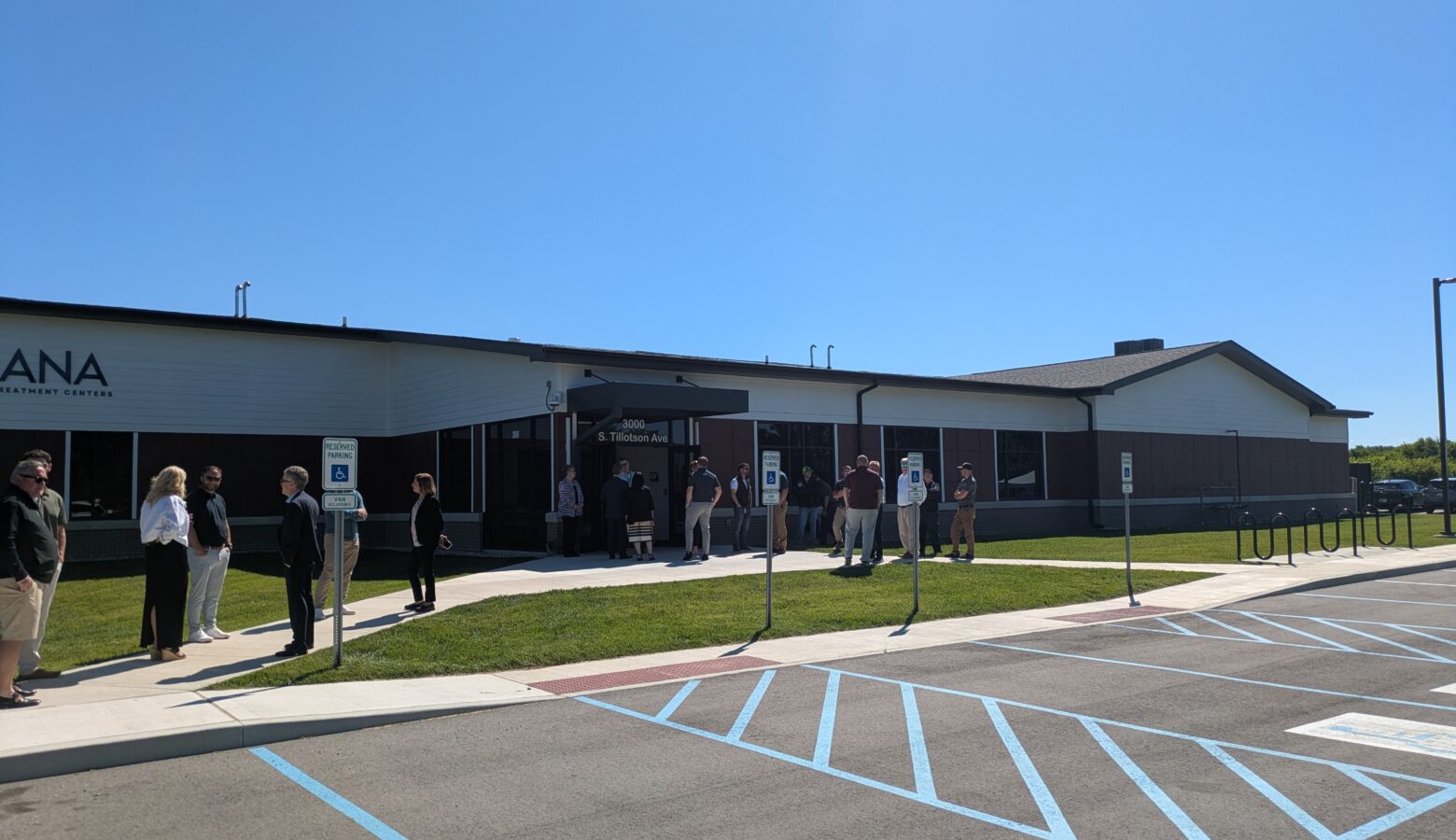 The Delaware County addiction treatment center is a one-story red and while-sided building surrounded by a parking lot.