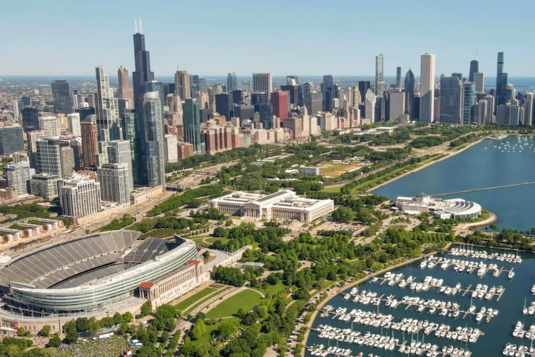 An ariel view of a city. A sports stadium is located in the bottom left.