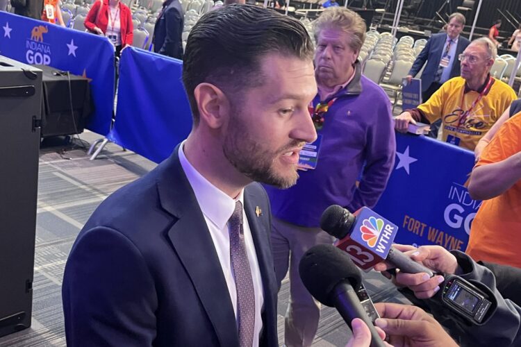 Max Engling stands on the floor of the Republican state convention and answers questions from reporters.