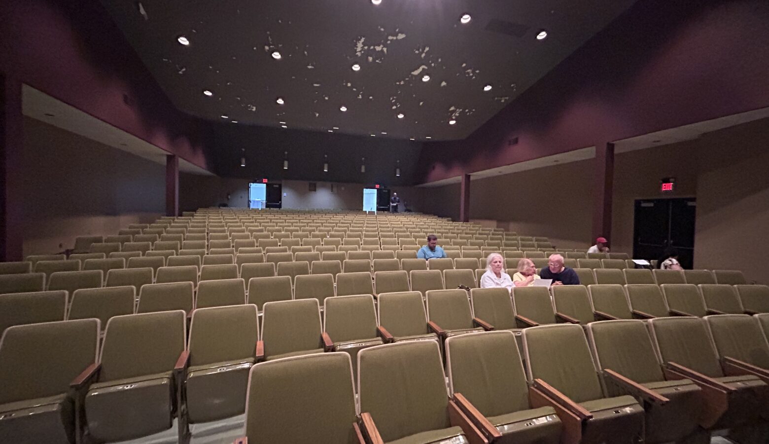 A large auditorium with very few audience members in it