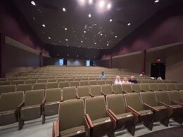A large auditorium with very few audience members in it