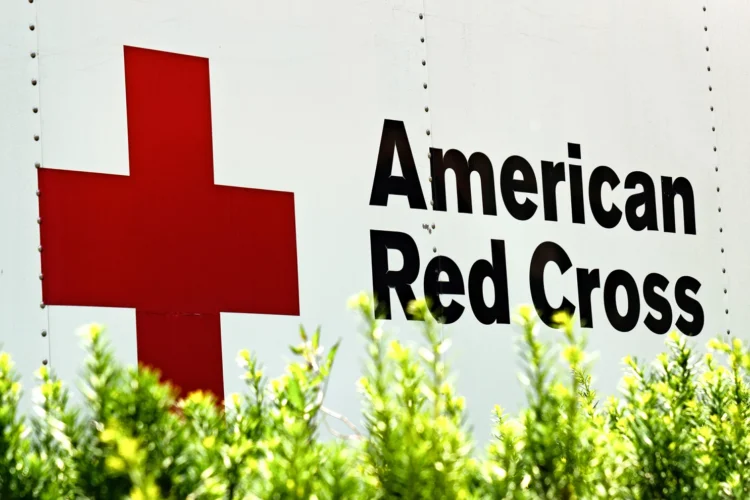 The American Red Cross logo of a large red cross is seen on the side of a bloodmobile.