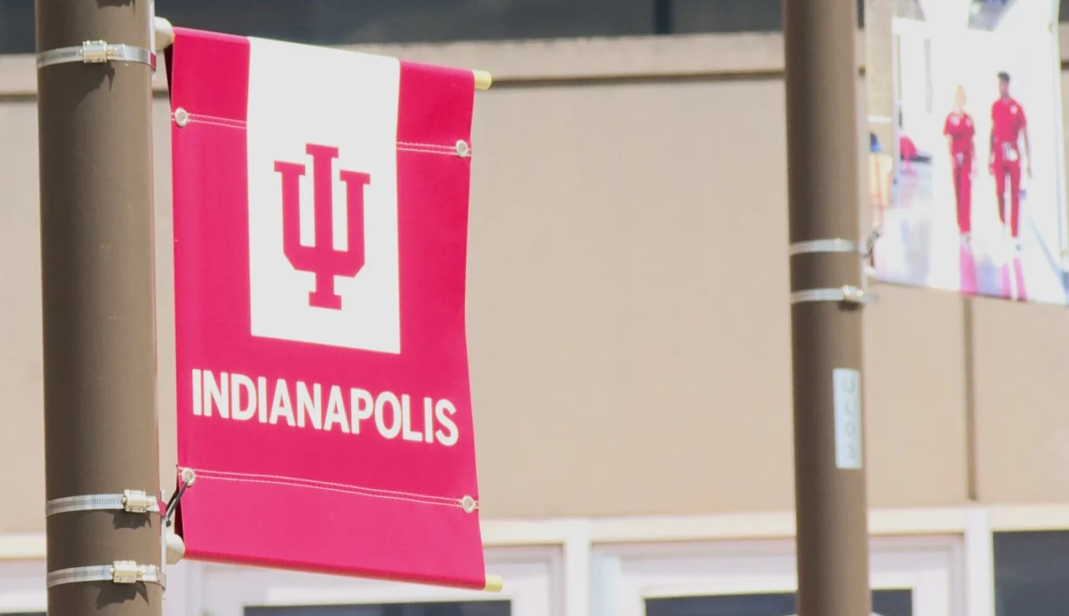 A red and white lamppost banner displays the IU logo with INDIANAPOLIS printed below.