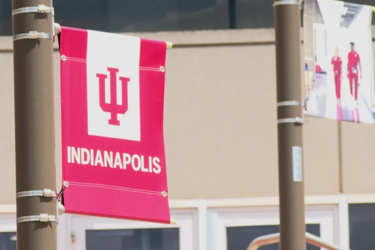A red and white lamppost banner displays the IU logo with INDIANAPOLIS printed below.