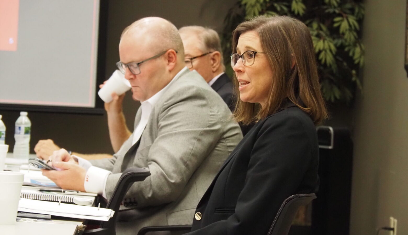 Hoosier Lottery commission members sit around a table, discussing the yearly revenue from the games.