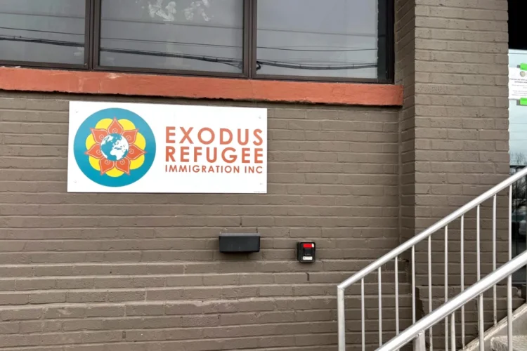 The side of a building with a sign for Exodus Refugee Immigration Inc