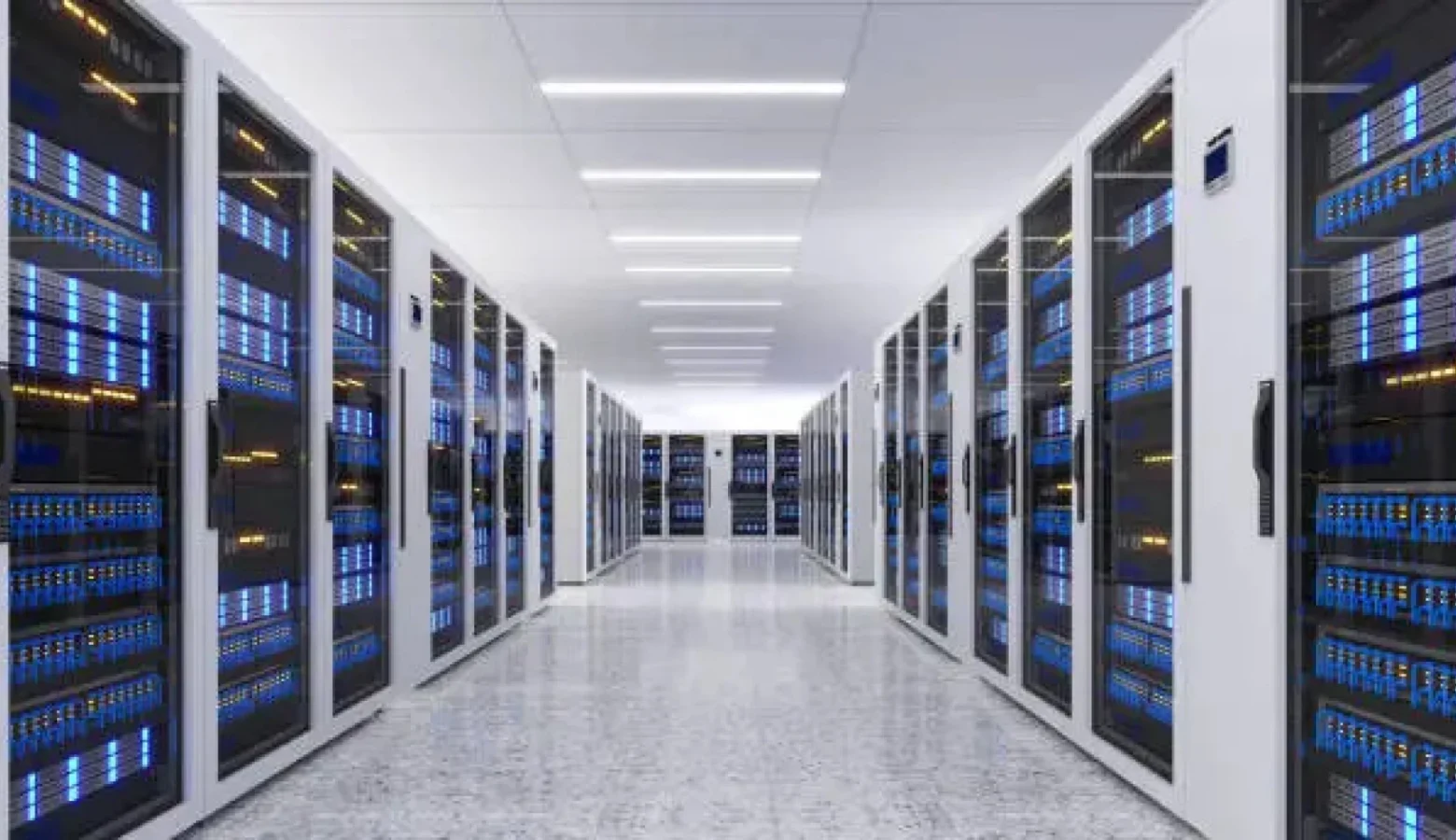 A clean, white hallway is lined with racks and racks full of servers and other digital components found in data centers.