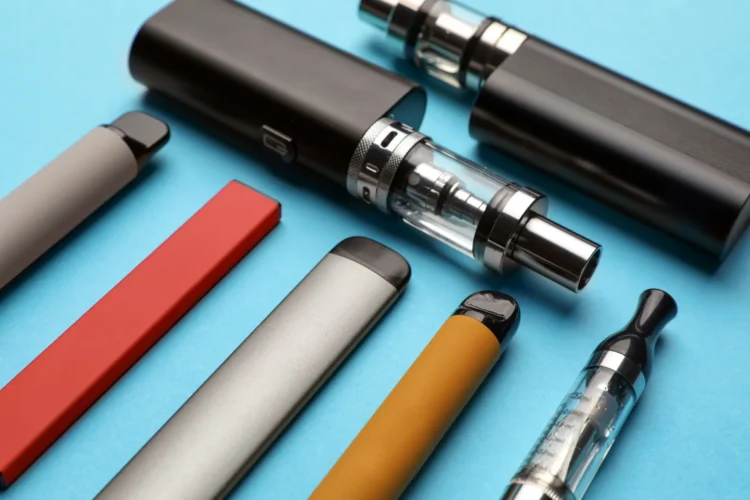 A collection of vape pens sit on a counter.