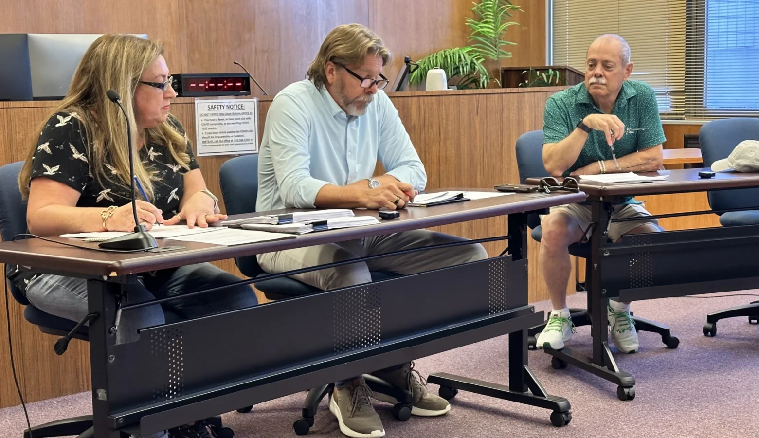 The Floyd County Election Board held an emergency meeting Friday, Oct. 9, 2026, after discovering hundreds of incomplete ballots issued to voters. Three members of the board, a woman and two men, are seated at a table in a wood-paneled meeting chamber with papers in front of them.