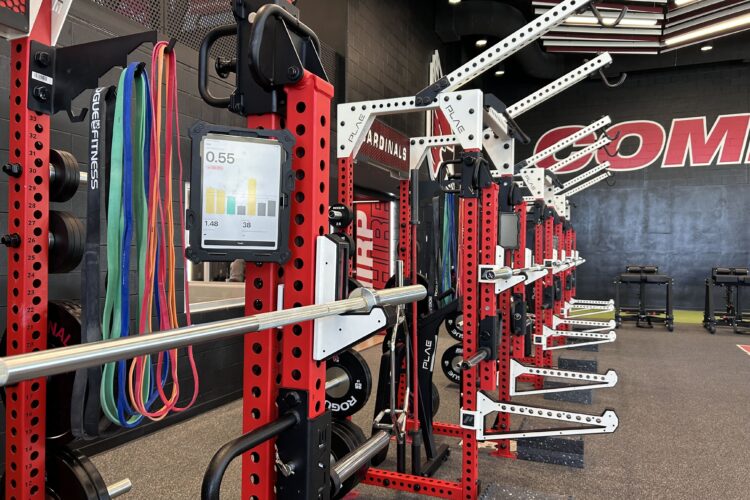 Rows of workout benches. Each of them as a small digital tablet fixed to them.