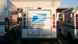 USPS vehicles parked in a row.