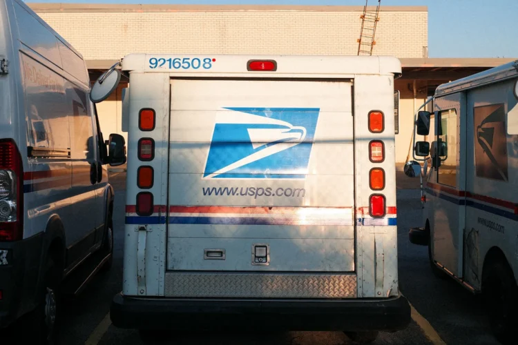 USPS vehicles parked in a row.